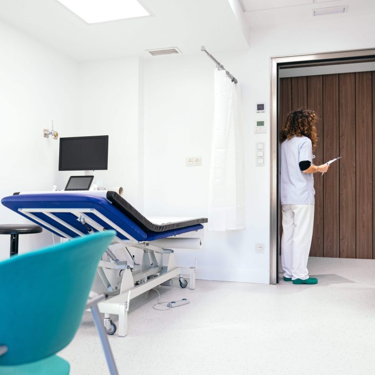 nurse-awaiting-patient-at-clinic-doorway-2025-03-08-07-25-15-utc (1)